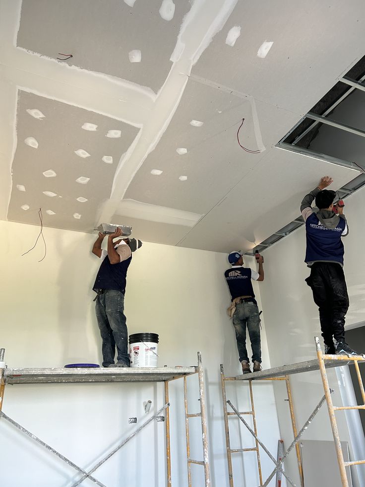 NorthRidge crew finishing a commercial ceiling from scaffolding